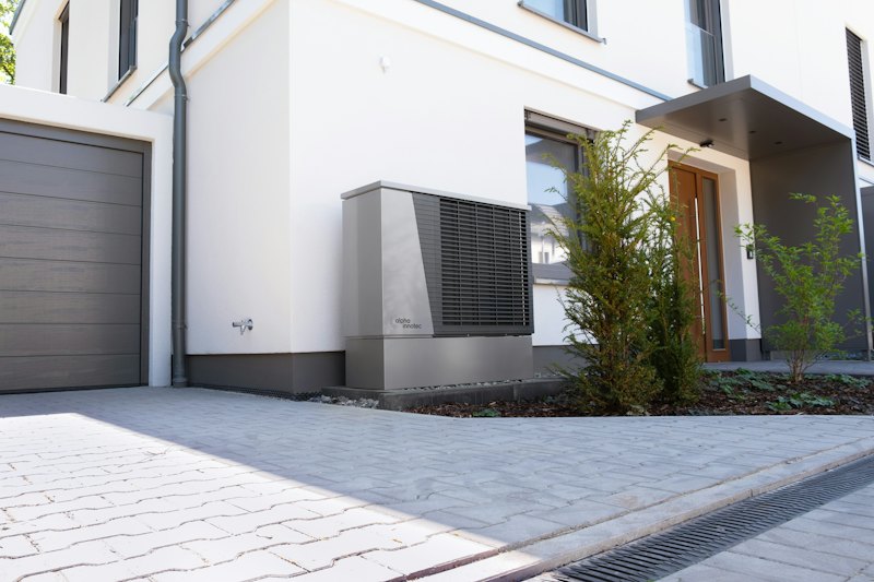 Outdoor heat pump unit installed beside a house